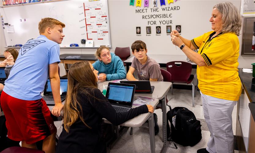 A teacher speaks to her class